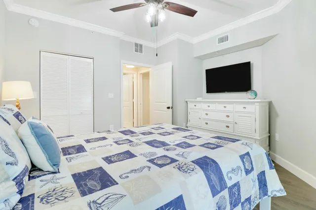 a bedroom with a bed a television and a couch