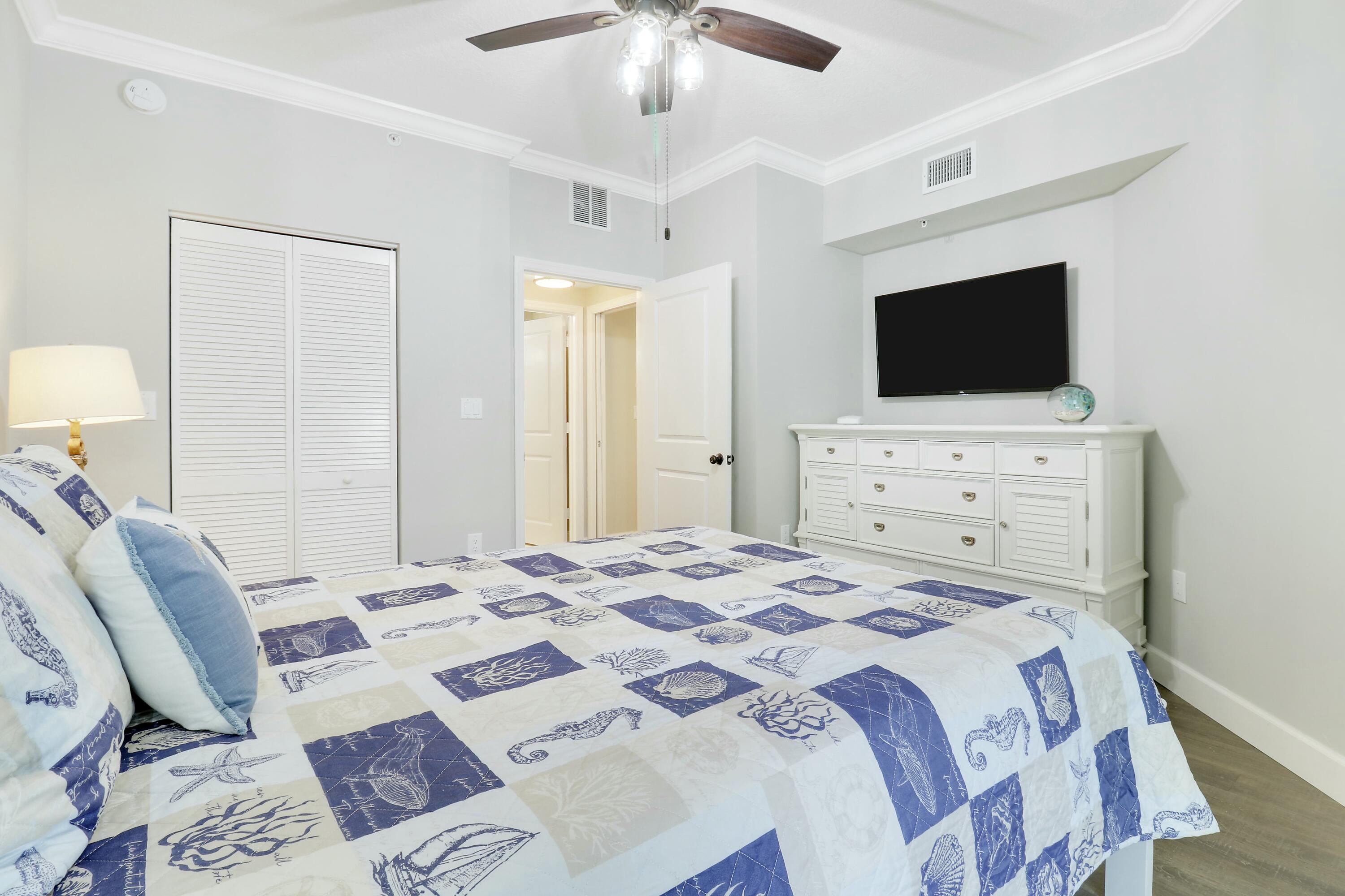 215 Northwest Flagler Avenue, Unit 301 Stuart, FL 34994 - Photo 29 of 34 a bedroom with a bed a television and a couch
