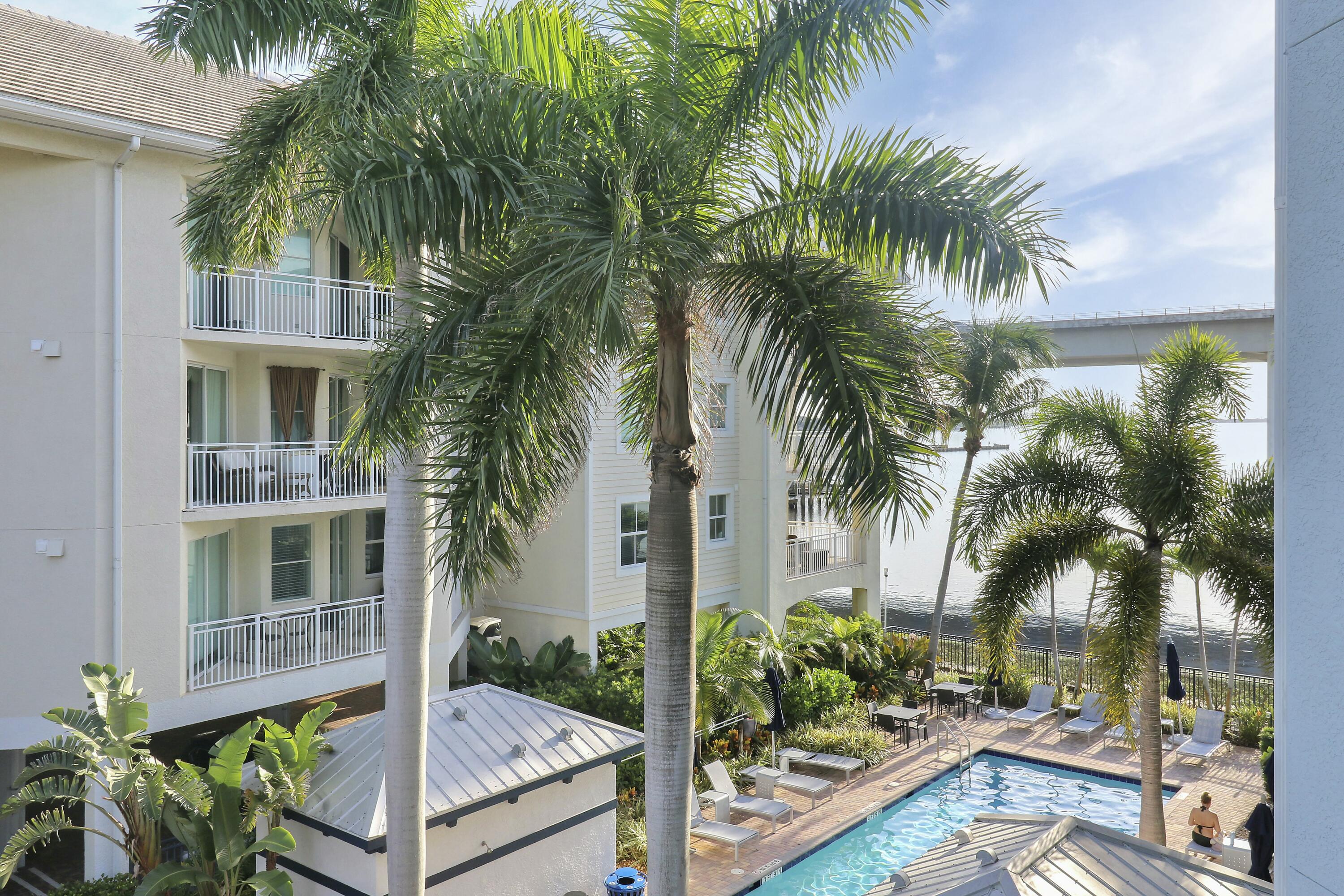 215 Northwest Flagler Avenue, Unit 301 Stuart, FL 34994 - Photo 30 of 34 a view of a backyard with palm trees