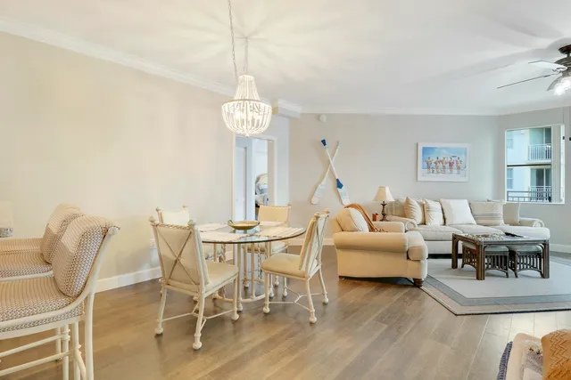 a living room with furniture a chandelier and a window