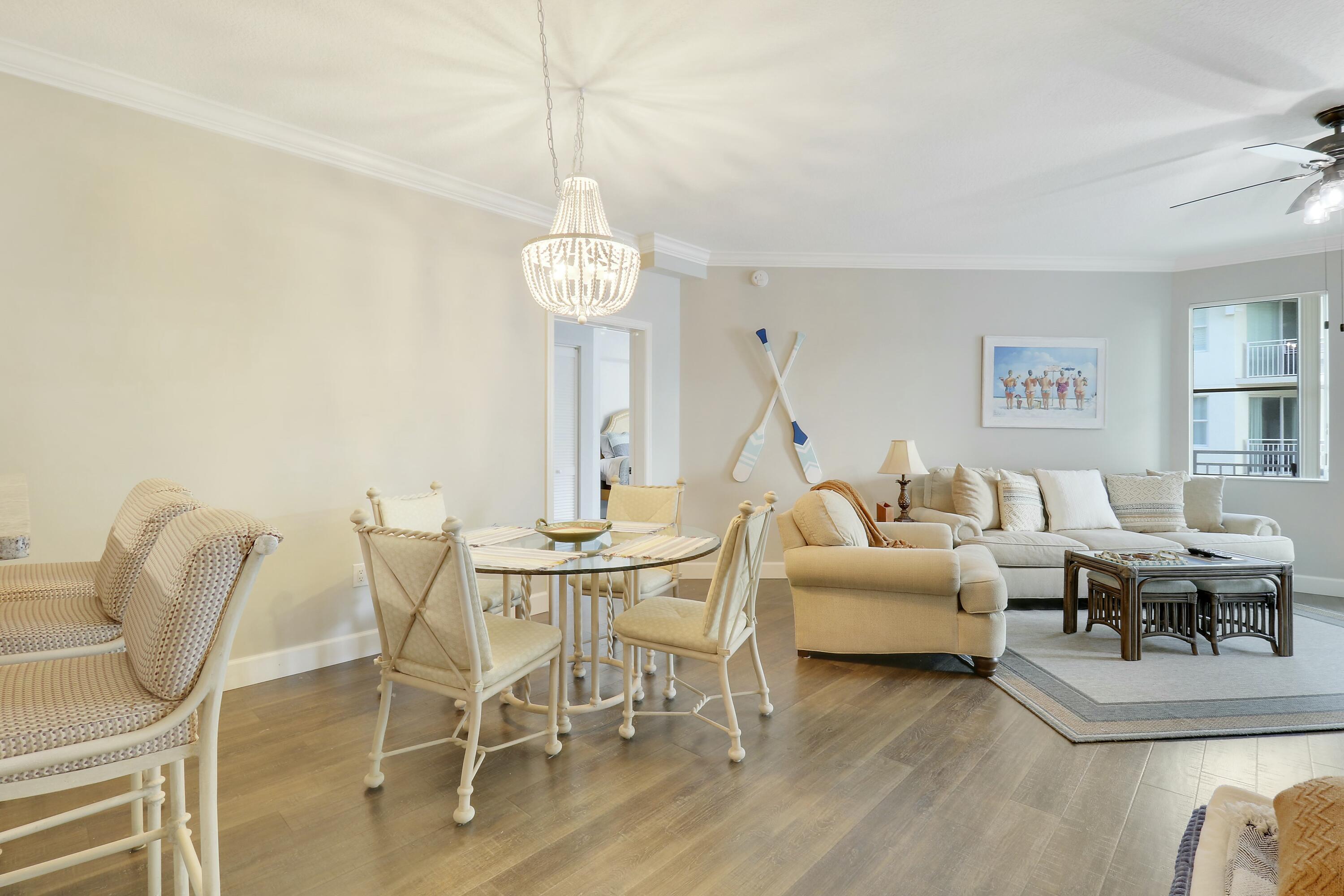 215 Northwest Flagler Avenue, Unit 301 Stuart, FL 34994 - Photo 8 of 34 a living room with furniture a chandelier and a window