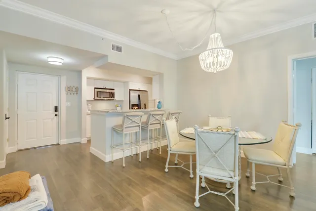 a view of a dining room with furniture and chandelier