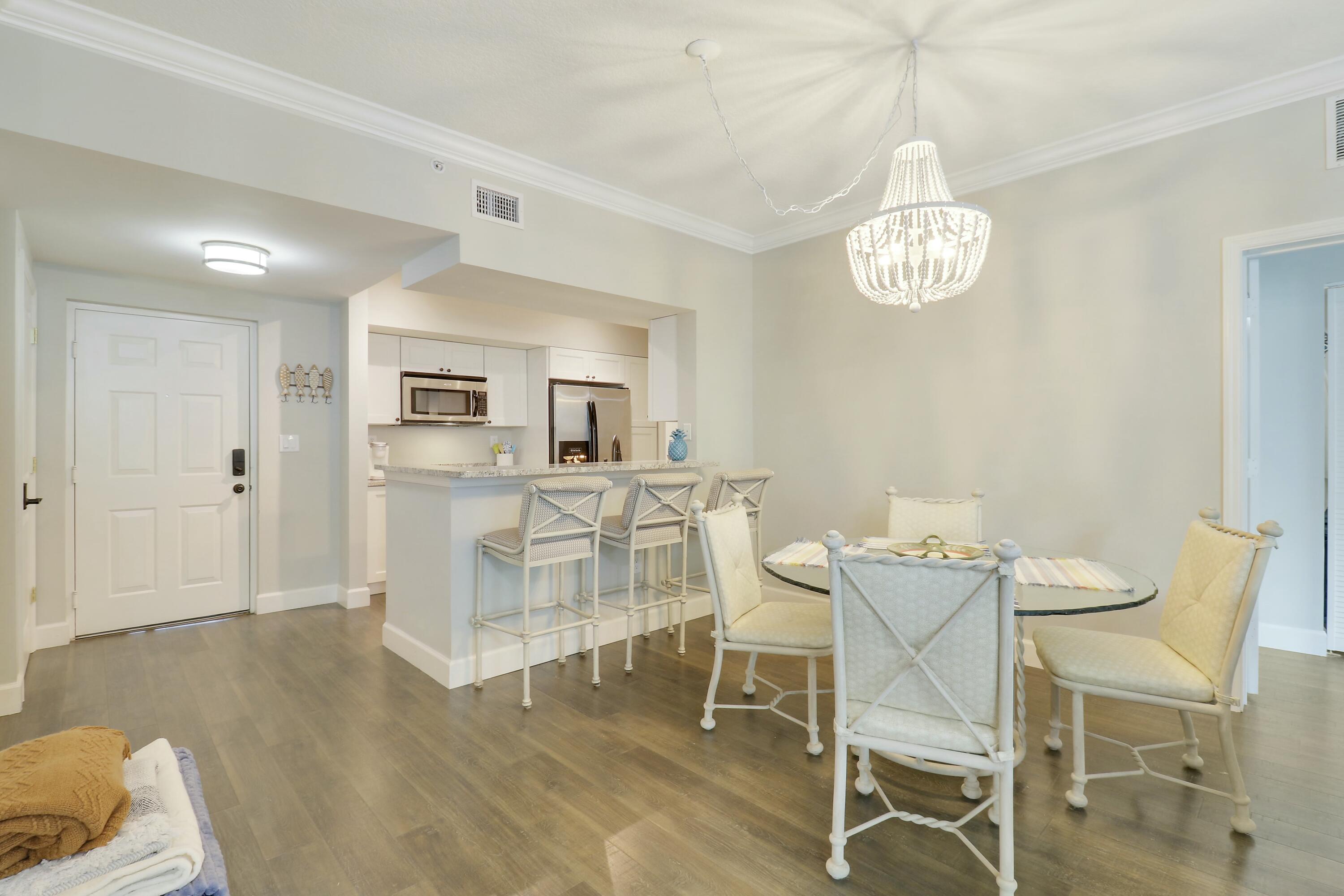 215 Northwest Flagler Avenue, Unit 301 Stuart, FL 34994 - Photo 9 of 34 a view of a dining room with furniture and chandelier