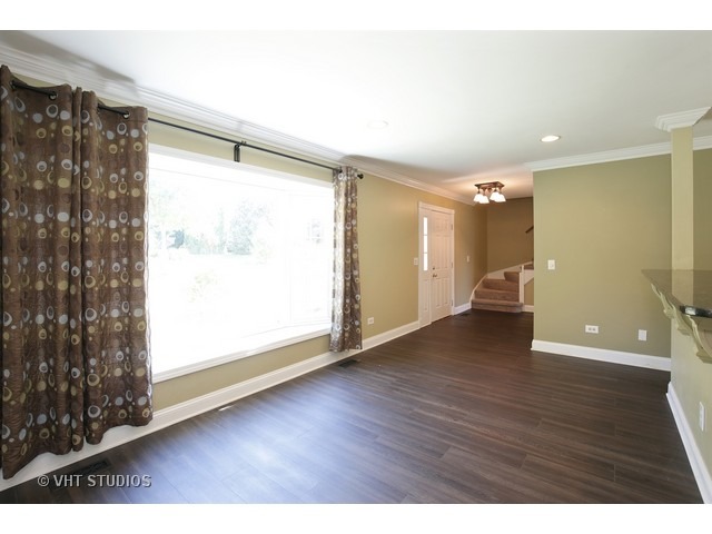 318 Old Hunt Road Fox River Grove, IL 60021 - Photo 3 of 20 a view of an empty room with wooden floor and a window