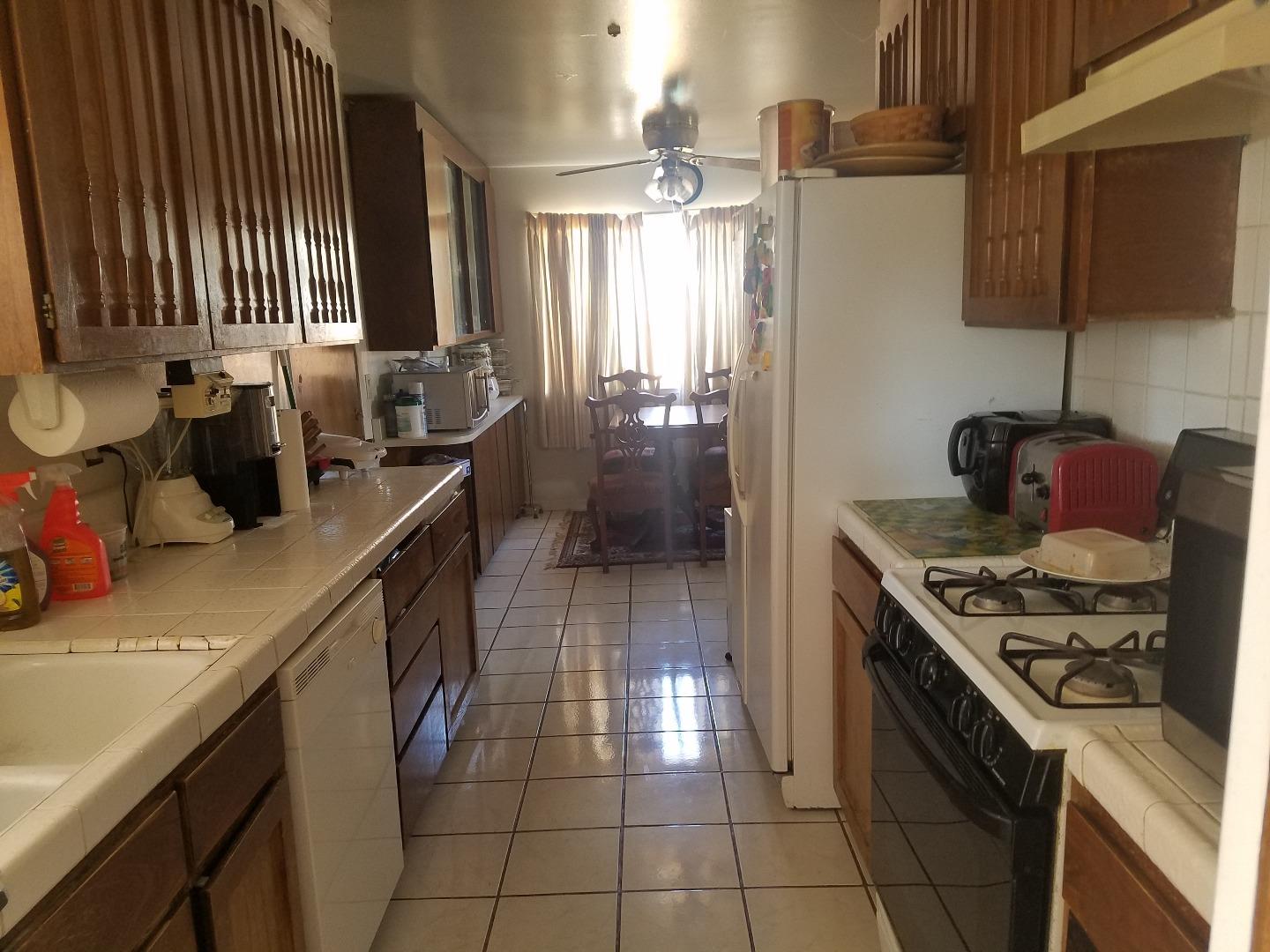 723 River Falls Drive San Jose, CA 95111 - Photo 13 of 20 a kitchen with a sink stove and cabinets
