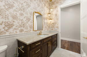1141 East Lost Ridge Drive Washington, UT 84780 - Photo 49 of 108 Vanity with brass hardware, undermount sink, and light-toned countertop