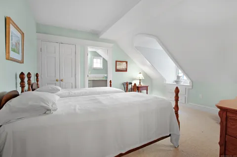 a bedroom with a bed and a large mirror