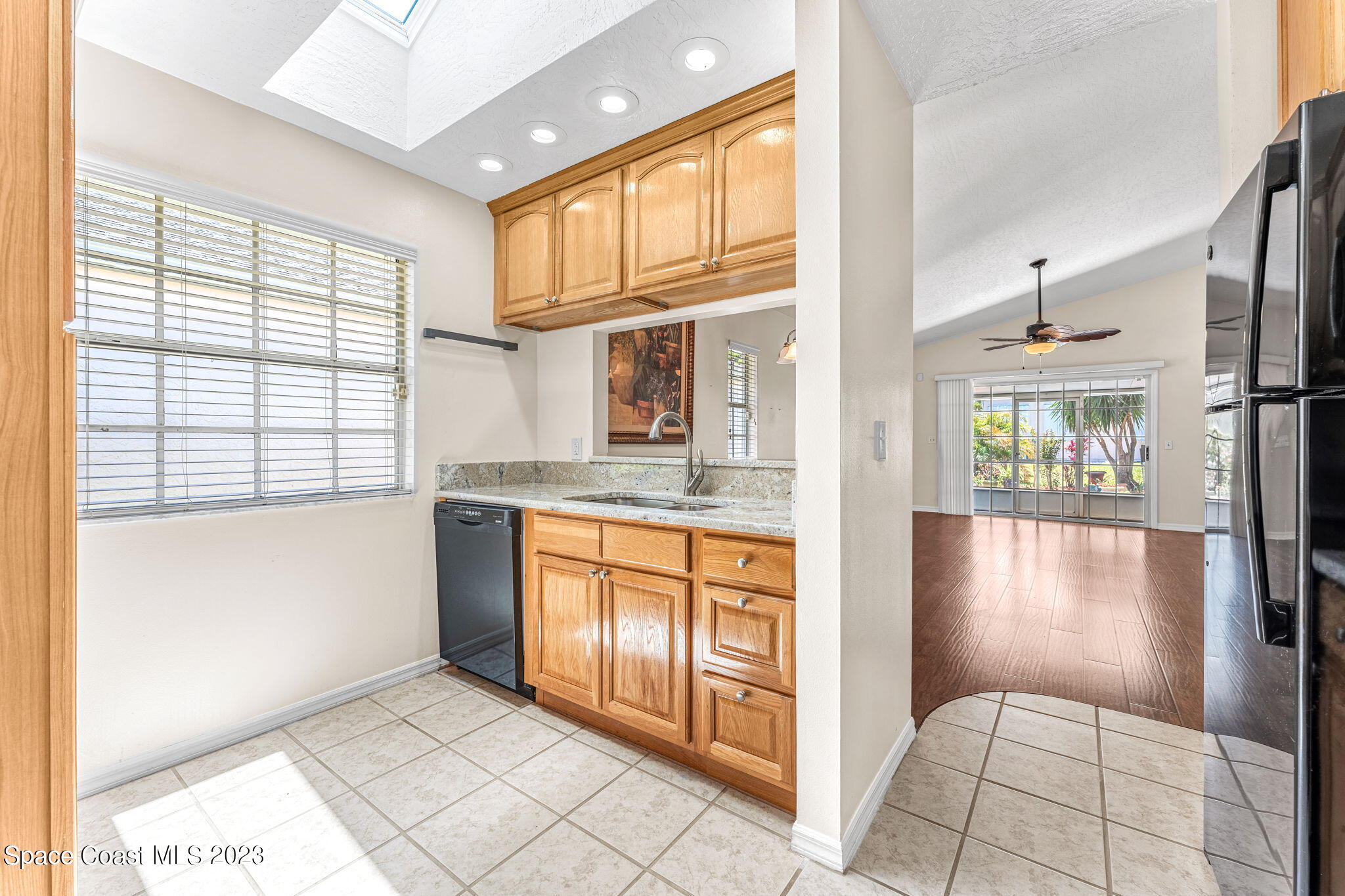 840 Cross Lake Drive Melbourne, FL 32901 - Photo 10 of 63 a view of a kitchen with kitchen island granite countertop a refrigerator and a sink
