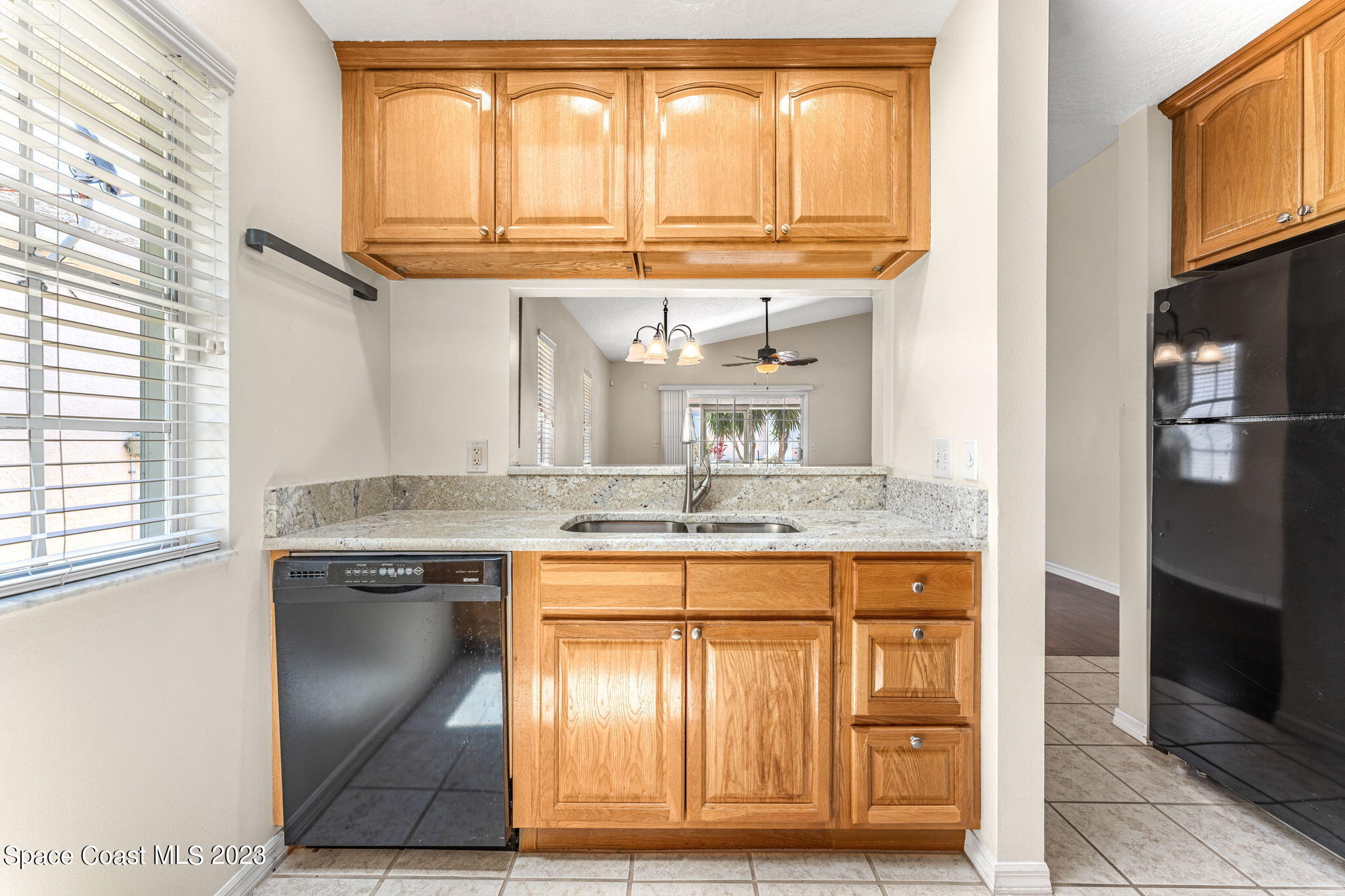 840 Cross Lake Drive Melbourne, FL 32901 - Photo 12 of 63 a kitchen with stainless steel appliances granite countertop a sink and a refrigerator