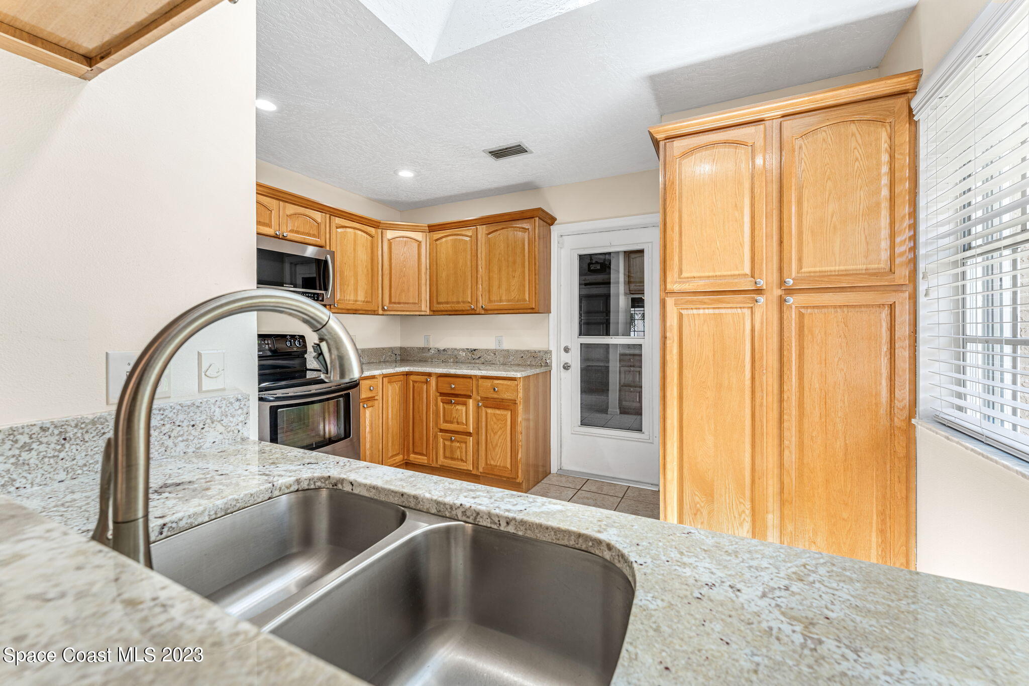 840 Cross Lake Drive Melbourne, FL 32901 - Photo 13 of 63 a kitchen with a refrigerator sink and cabinets