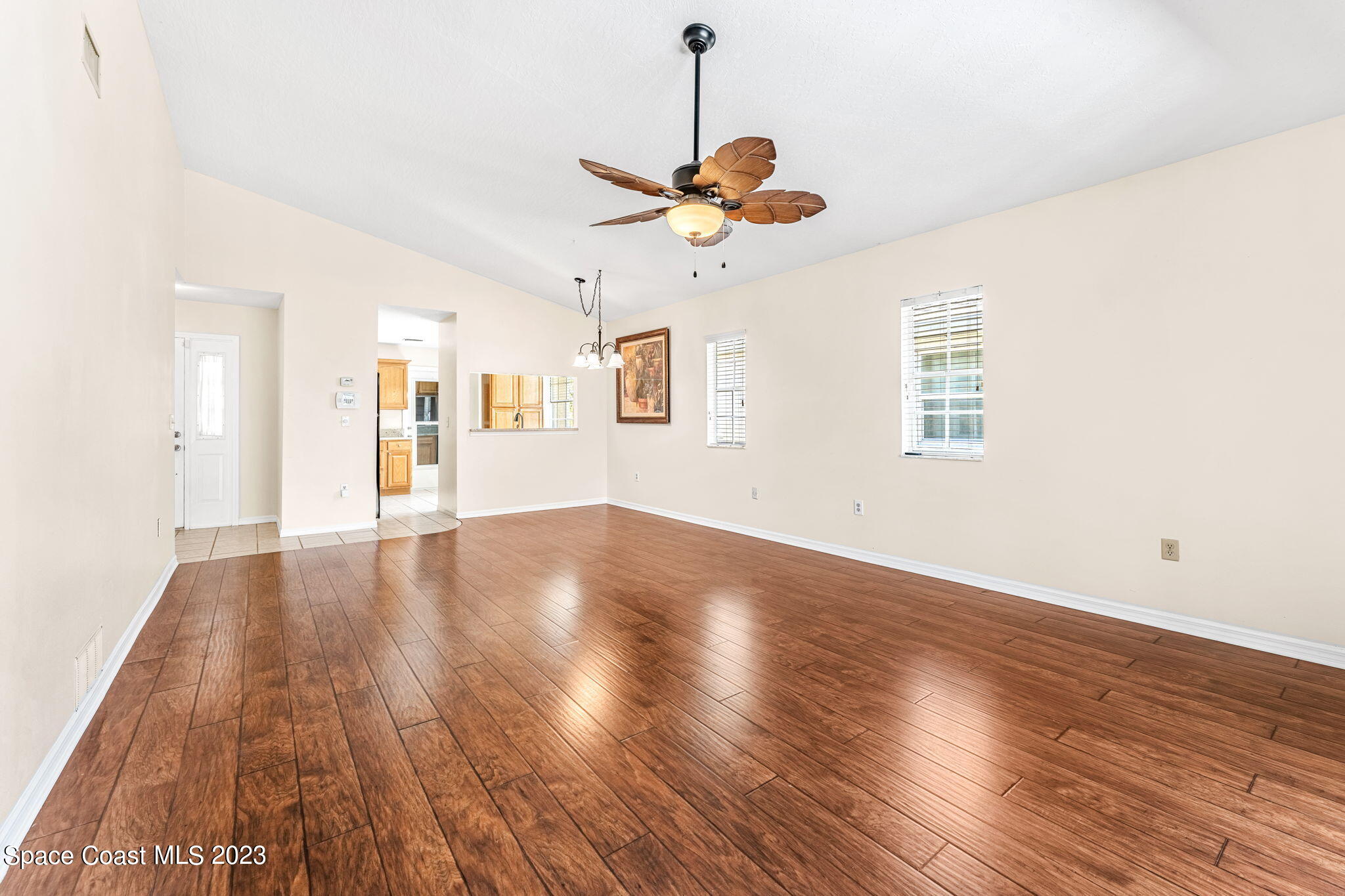 840 Cross Lake Drive Melbourne, FL 32901 - Photo 18 of 63 a view of an empty room with wooden floor and a window