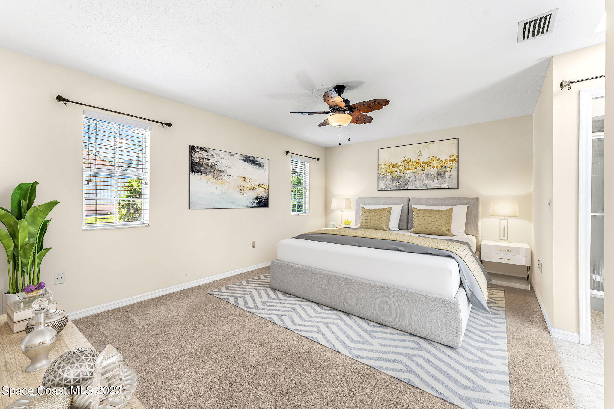 840 Cross Lake Drive Melbourne, FL 32901 - Photo 21 of 63 a bedroom with a large bed and a window