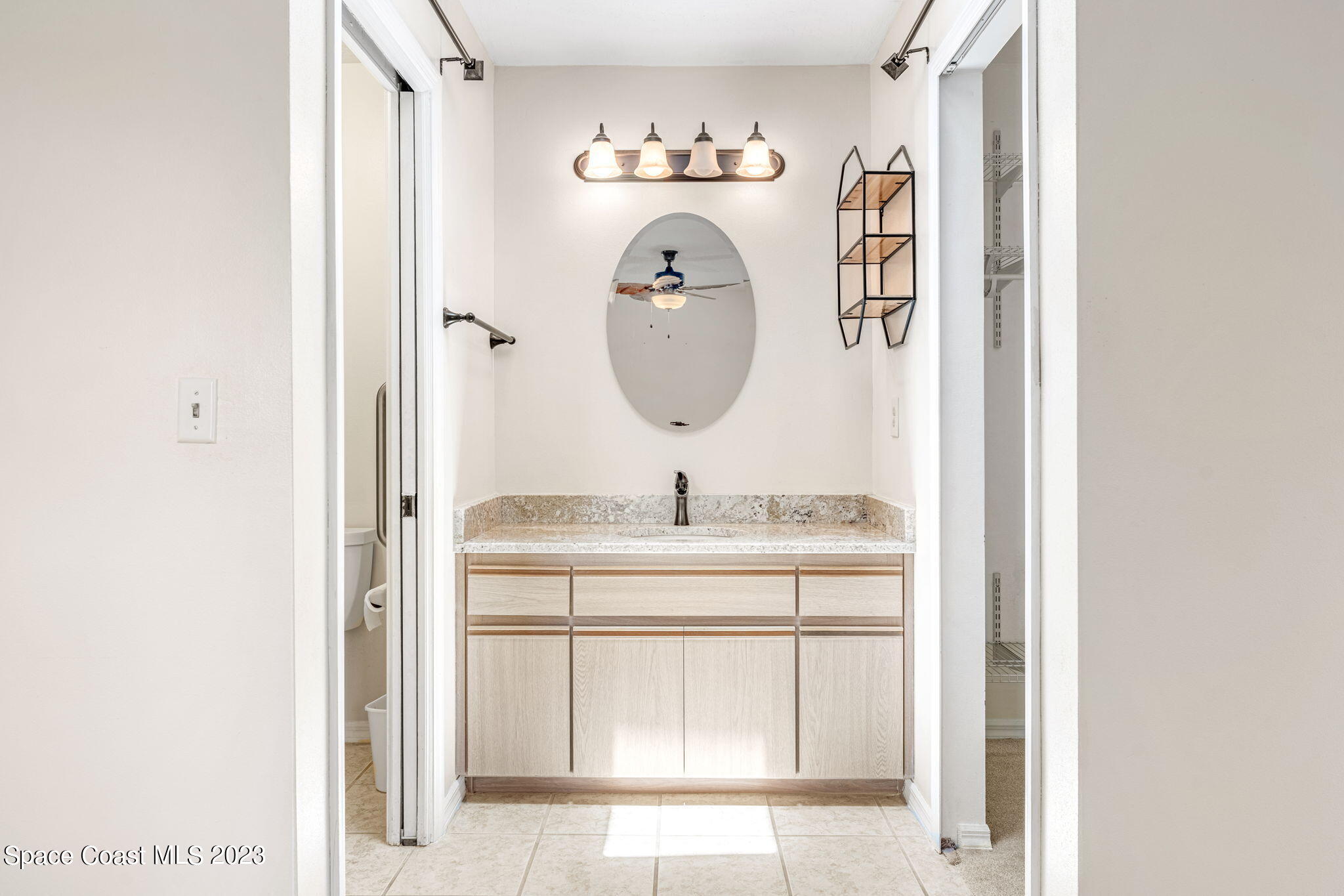 840 Cross Lake Drive Melbourne, FL 32901 - Photo 24 of 63 a bathroom with a sink and a mirror