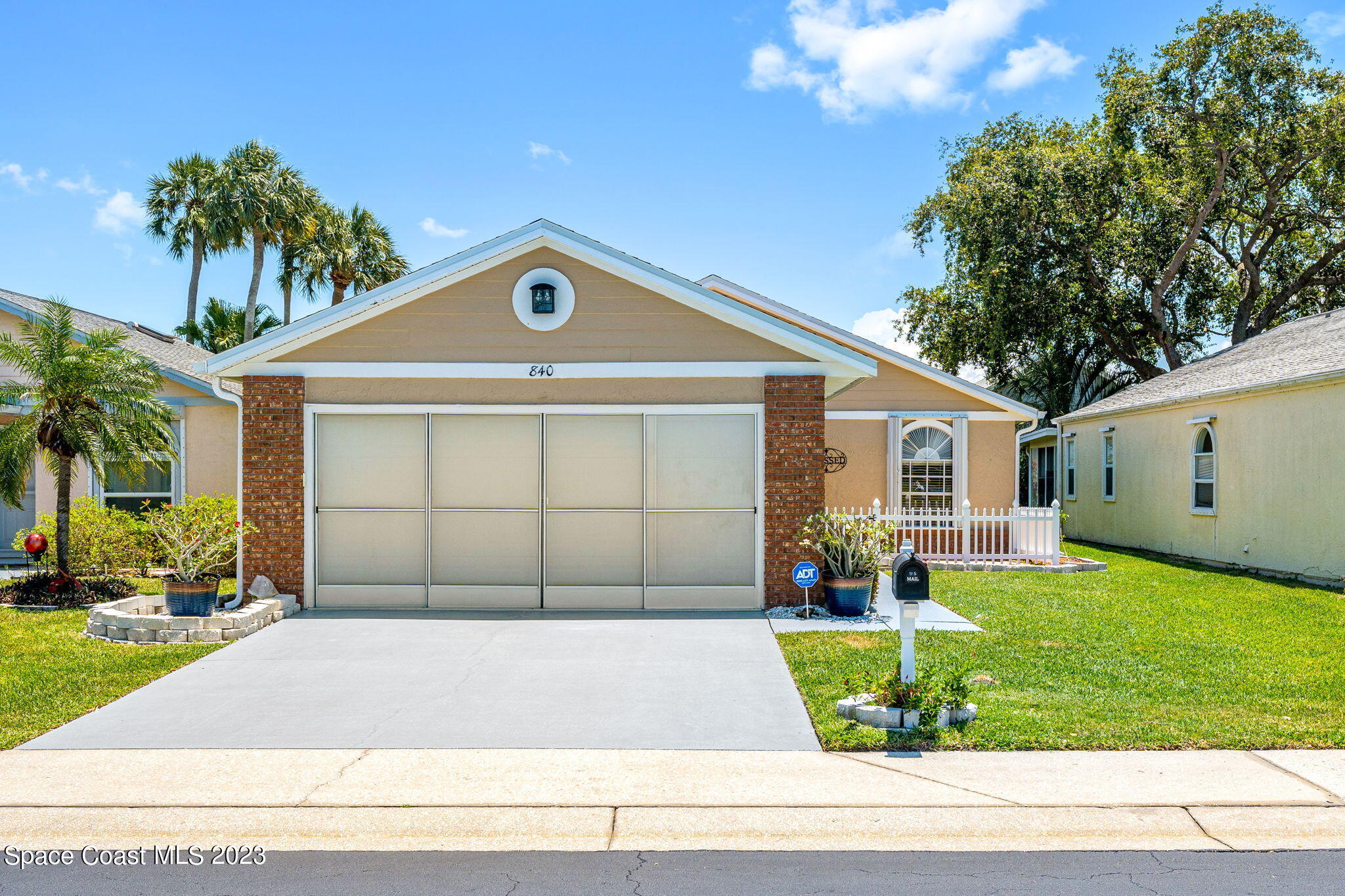 840 Cross Lake Drive Melbourne, FL 32901 - Photo 34 of 63 a front view of a house with a yard and garage