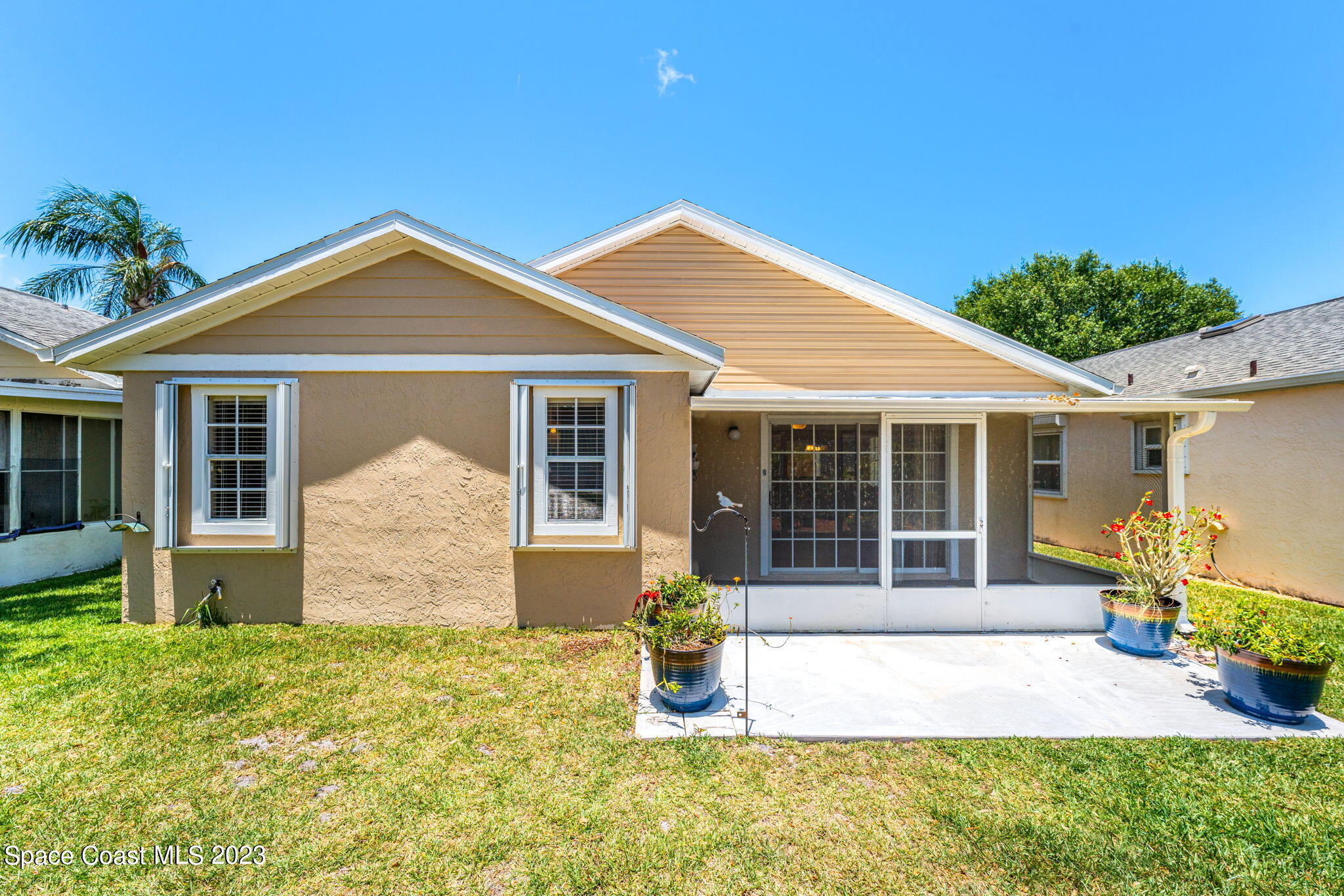 840 Cross Lake Drive Melbourne, FL 32901 - Photo 3 of 63 a front view of a house with a garden and porch