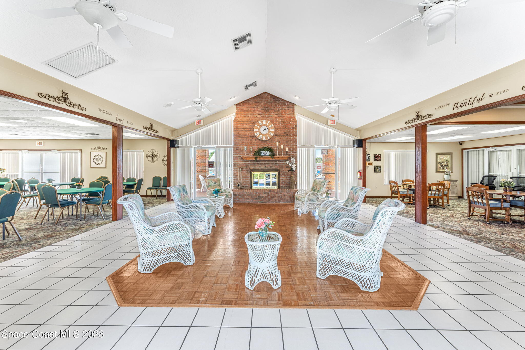 840 Cross Lake Drive Melbourne, FL 32901 - Photo 47 of 63 a living room with couches a table and chairs with wooden floor