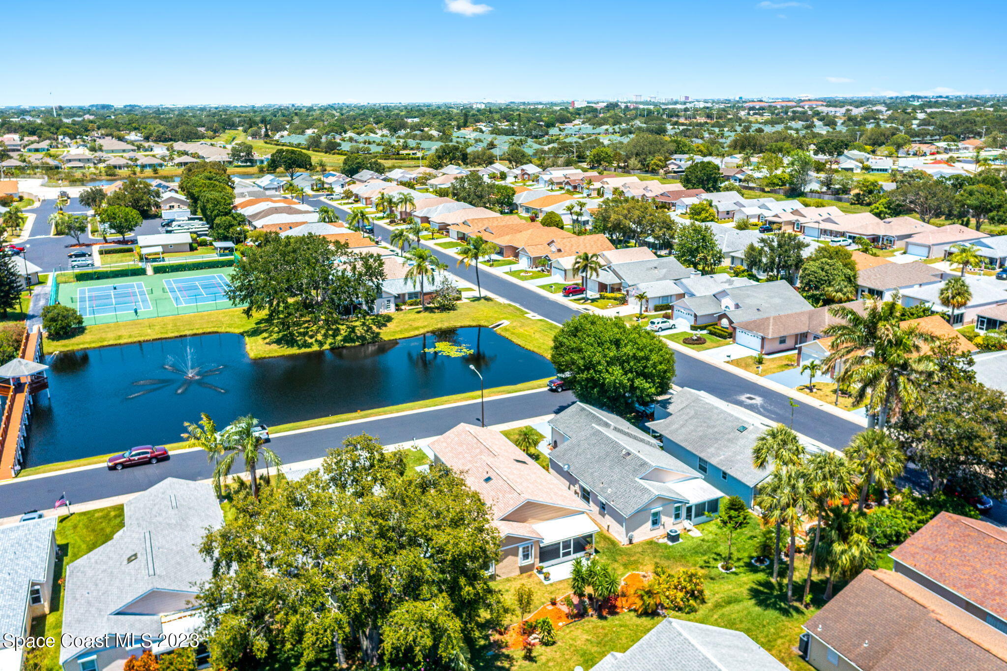 840 Cross Lake Drive Melbourne, FL 32901 - Photo 55 of 63 an aerial view of a city with lots of residential buildings ocean and mountain view in back