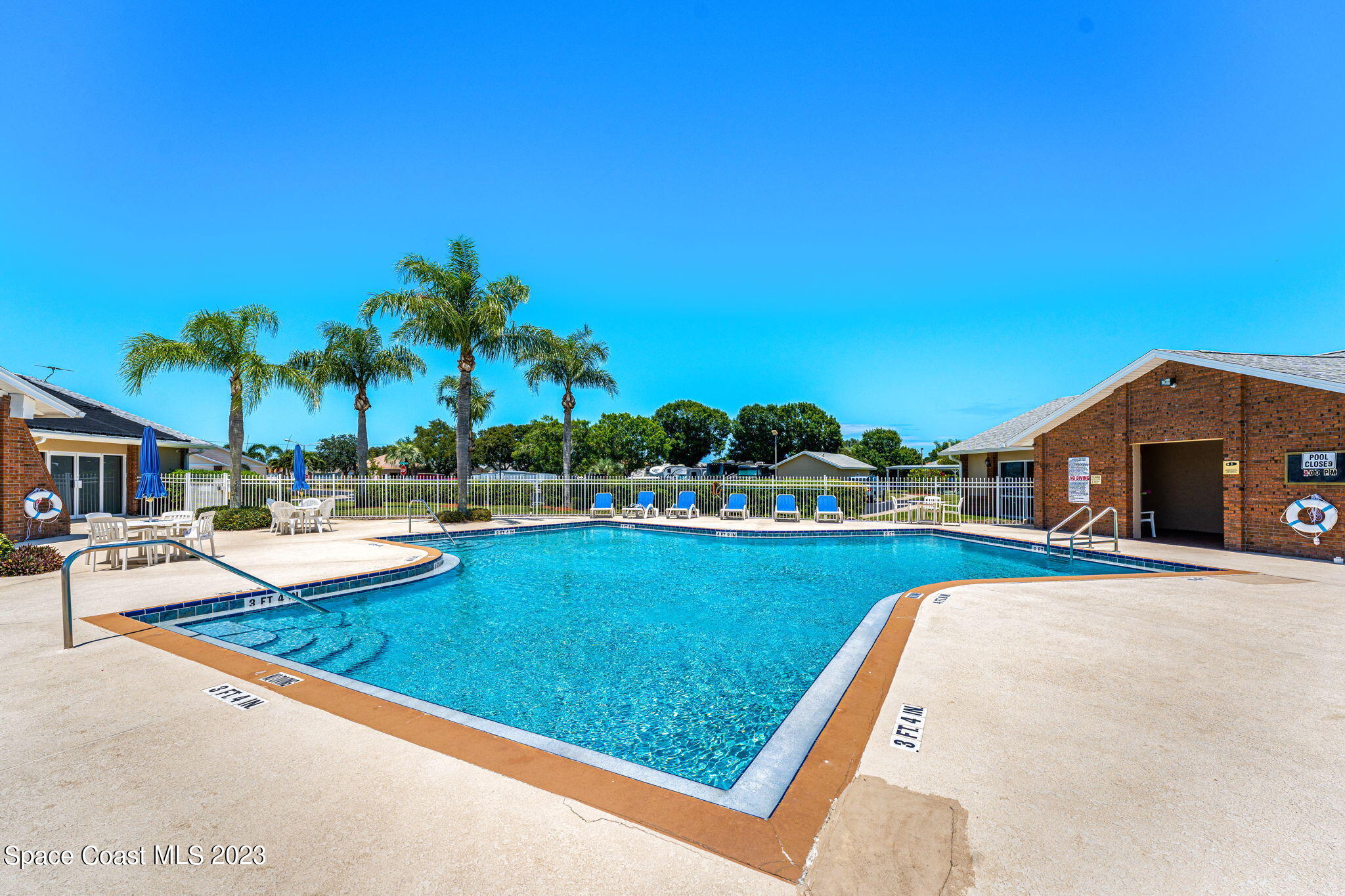 840 Cross Lake Drive Melbourne, FL 32901 - Photo 6 of 63 a view of swimming pool with outdoor seating and a garden