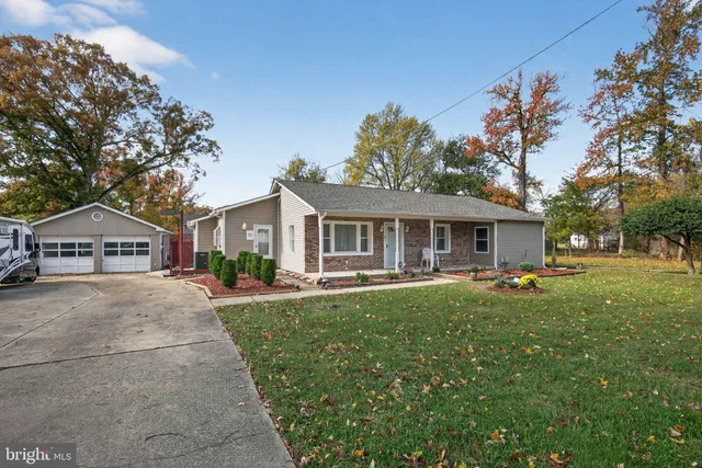 a front view of house with yard and outdoor seating