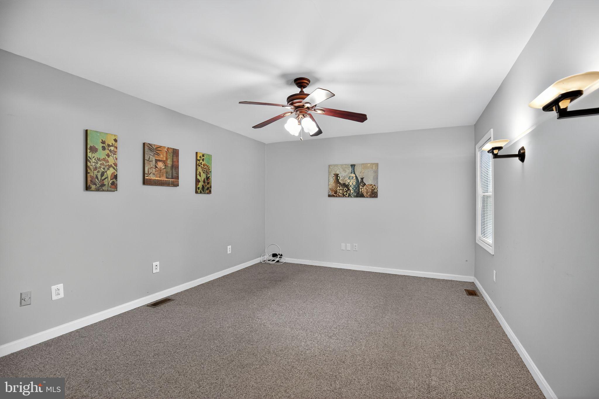 7726 Wills Lane Fort Washington, MD 20744 - Photo 19 of 30 a view of a room with a ceiling fan and a window
