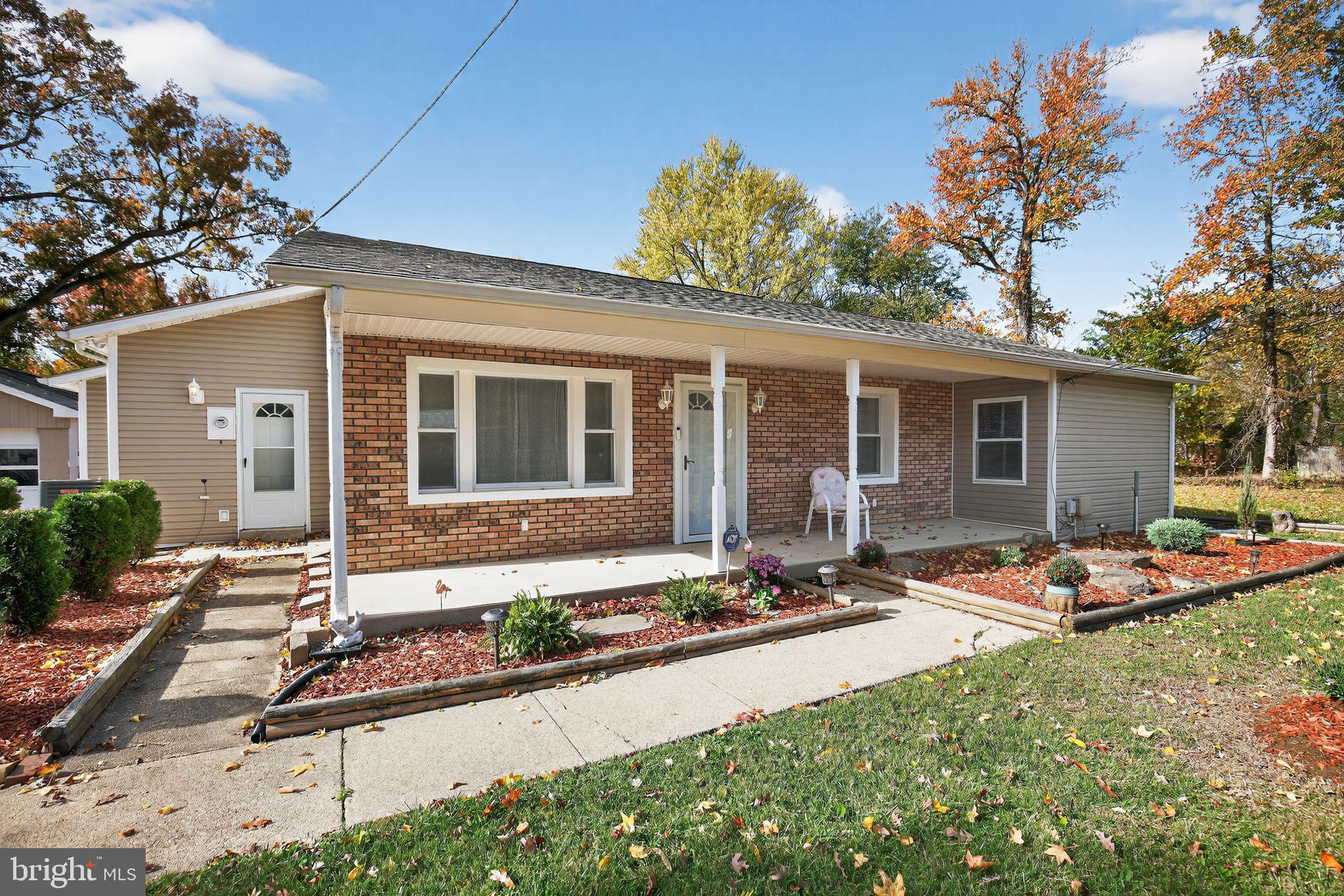 7726 Wills Lane Fort Washington, MD 20744 - Photo 2 of 30 a front view of house with yard outdoor seating and barbeque oven