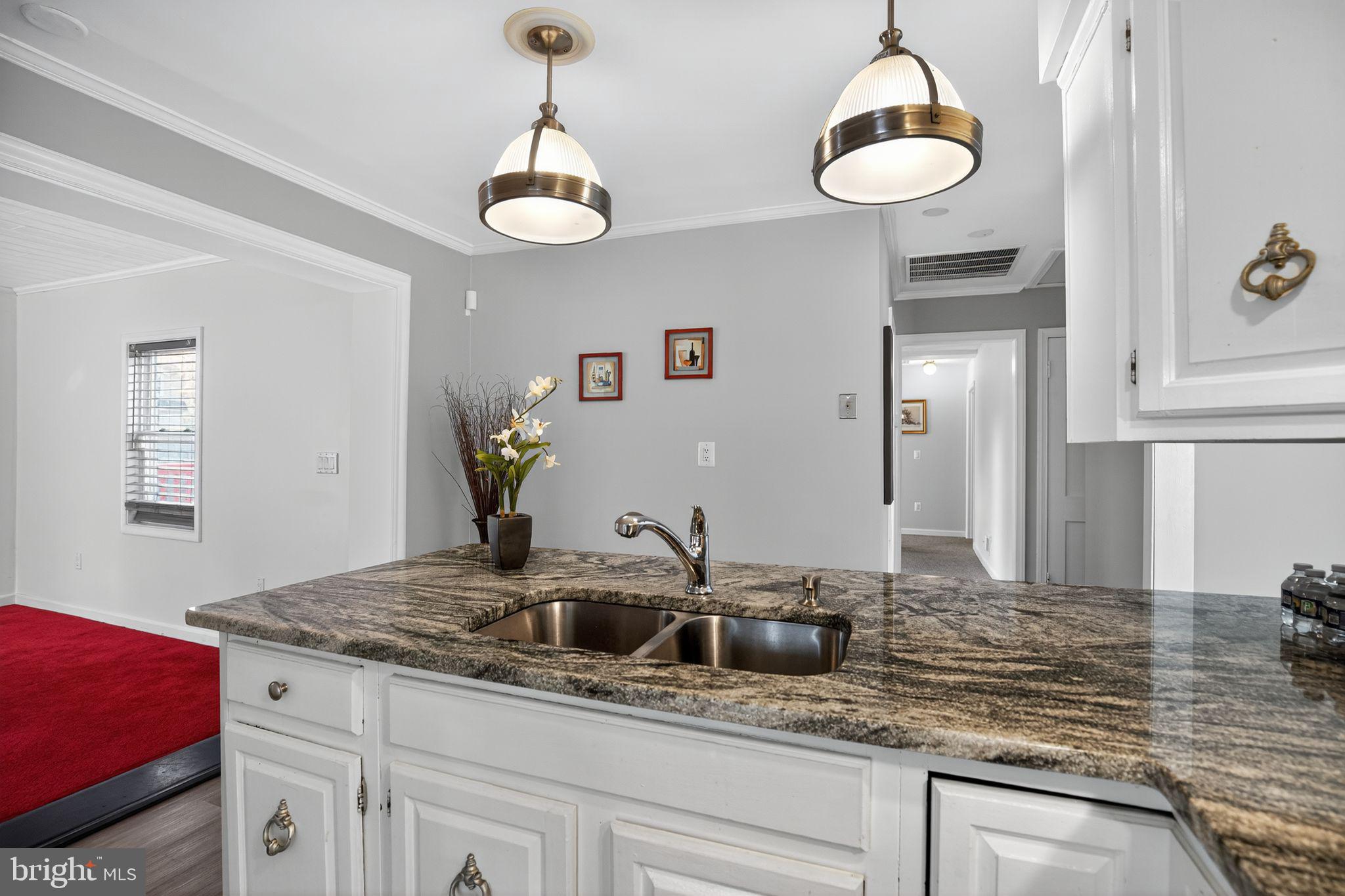 7726 Wills Lane Fort Washington, MD 20744 - Photo 7 of 30 a kitchen with stainless steel appliances granite countertop a sink a stove and a wooden cabinets