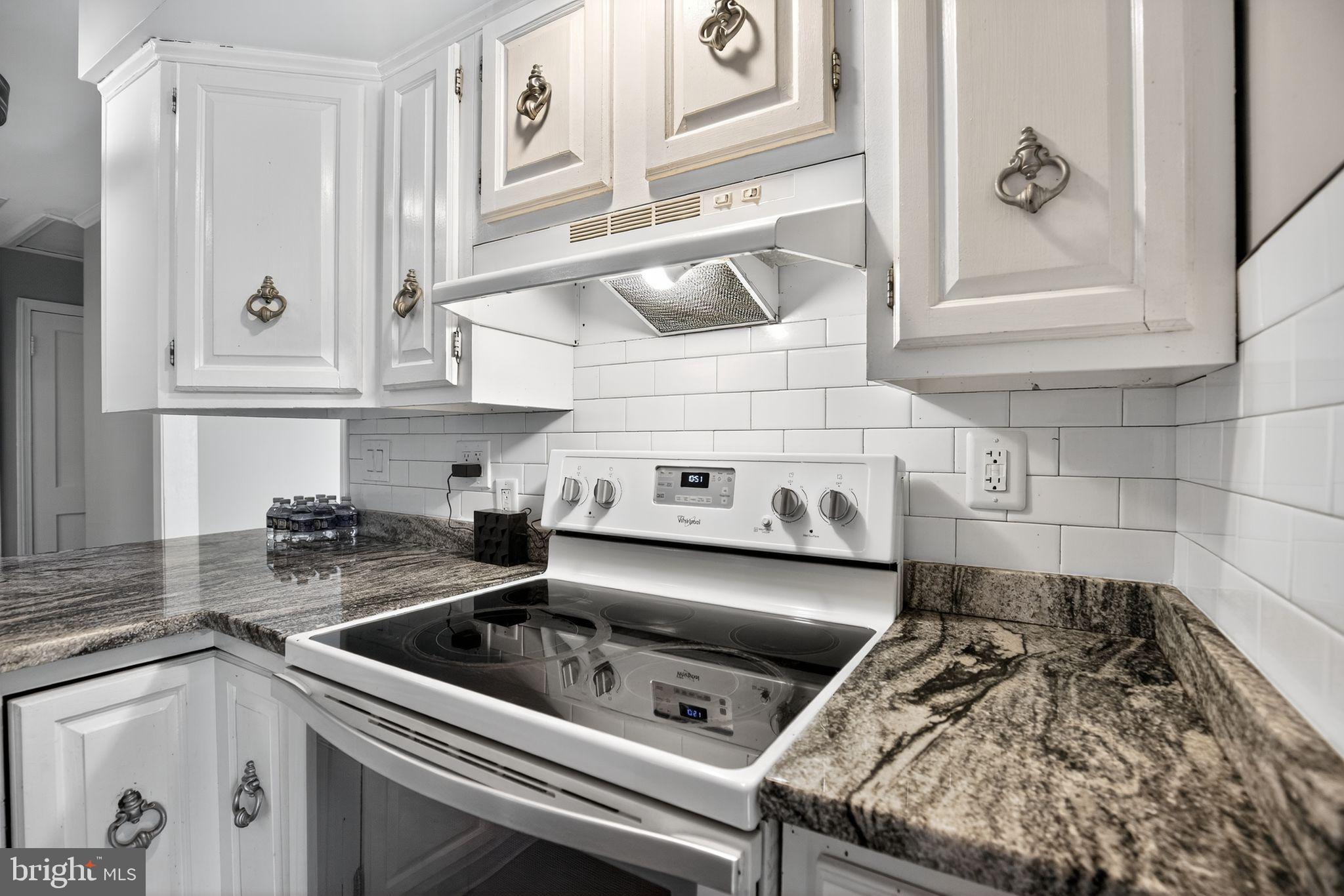 7726 Wills Lane Fort Washington, MD 20744 - Photo 8 of 30 a kitchen with a stove a sink and cabinets