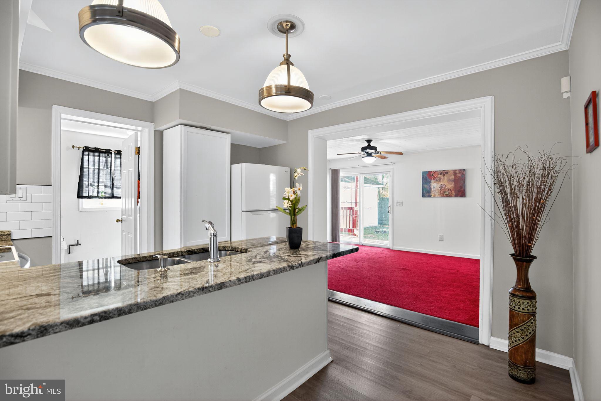 7726 Wills Lane Fort Washington, MD 20744 - Photo 9 of 30 a living room with granite countertop couches with wooden floor