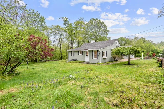 a backyard of a house with table and chairs