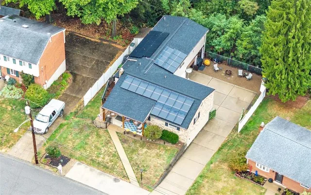 an aerial view of a house with a yard