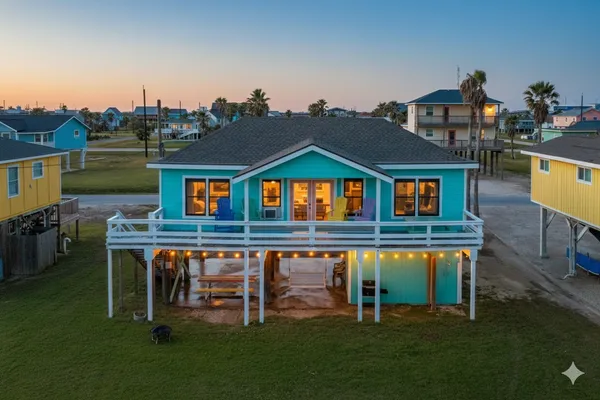 a living room with furniture and a open kitchen view