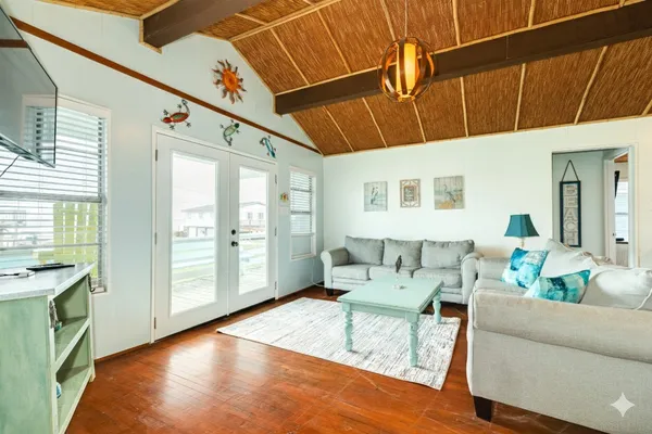a living room with furniture and a chandelier