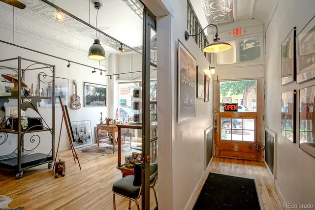 a view of a hallway with wooden floor and furniture