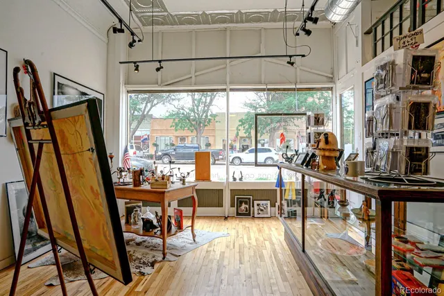 a view of a living room with furniture window and wooden floor