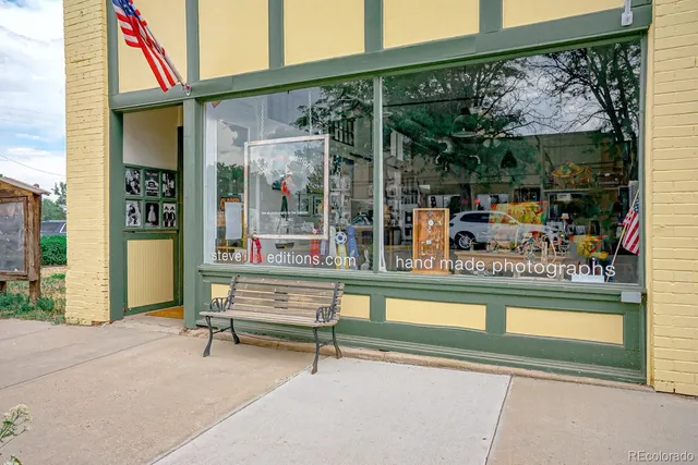 a view of a patio with a table and chairs under an umbrella