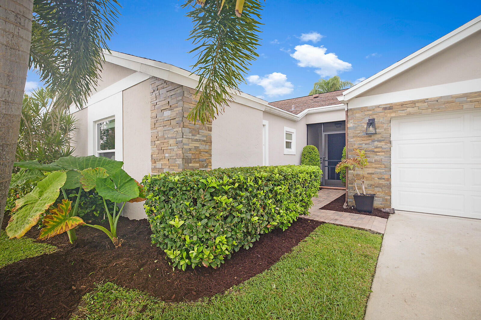21021 Windemere Lane Boca Raton, FL 33428 - Photo 4 of 48 a front view of a house with a yard