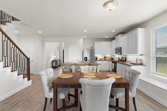 a dining room with kitchen island a table and chairs