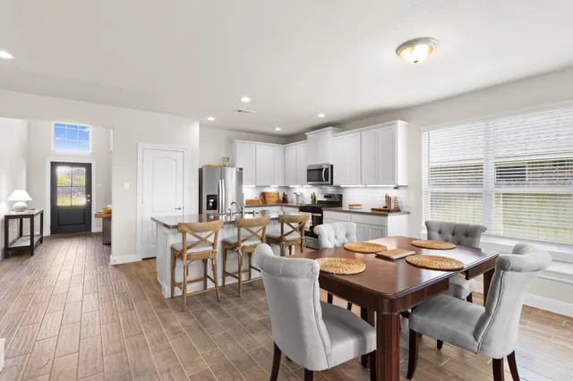 a view of a dining room with furniture and wooden floor