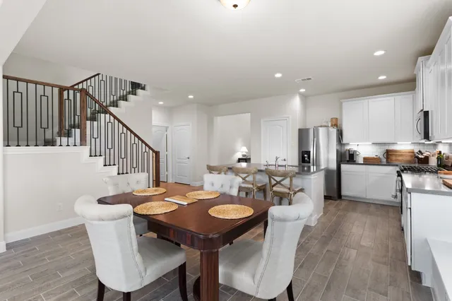 a view of a dining room with furniture and wooden floor