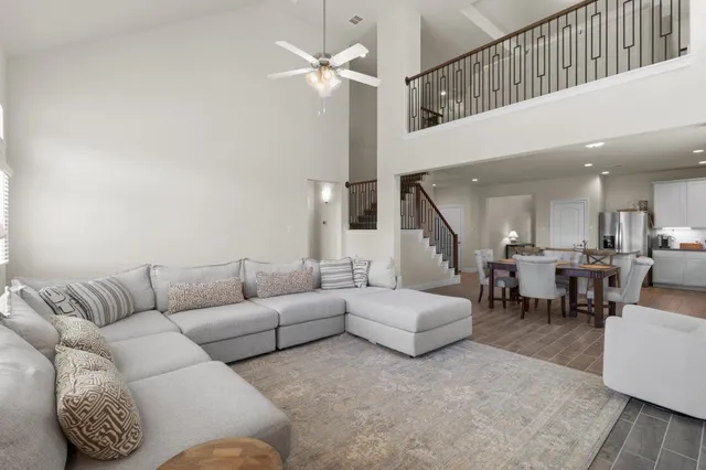 a living room with furniture and a chandelier