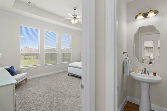 a en suite bathroom with a sink and a mirror