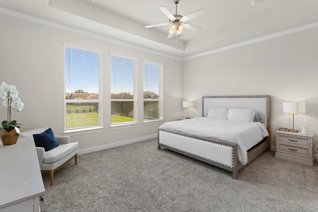 a spacious bedroom with a bed and a large window