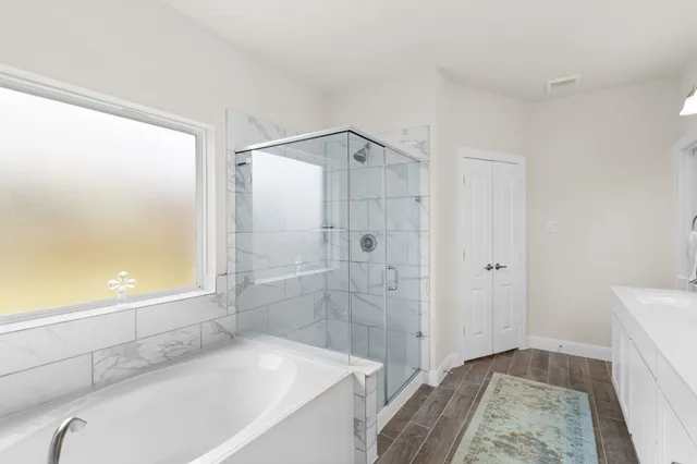 a bathroom with a tub and a shower