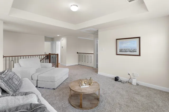 a living room with furniture and a lamp