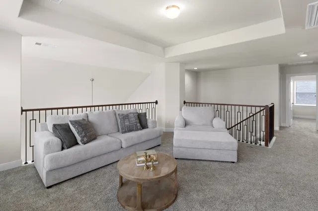 a living room with furniture and white walls
