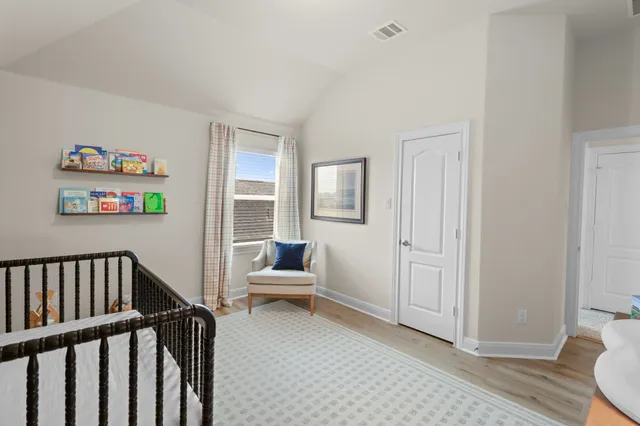 a view of a livingroom with wooden floor and furniture