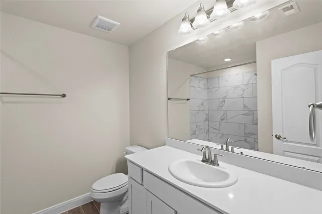 a bathroom with a sink toilet and shower