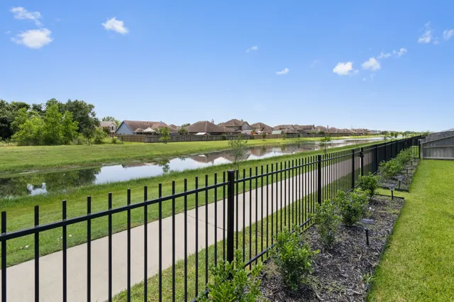 a view of a green field with an ocean view