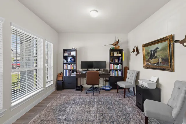 a workspace with furniture and a large window