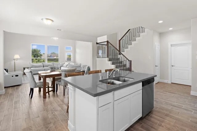 a kitchen with sink and cabinets